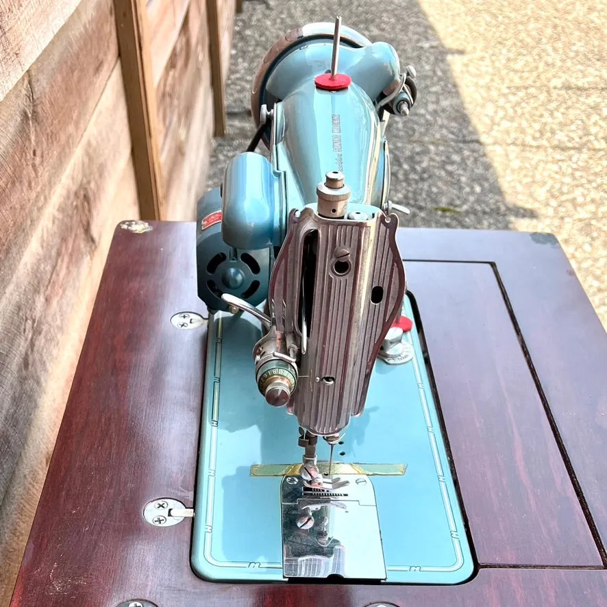 Sleek Modern Aqua Sewing Machine In Cabinet