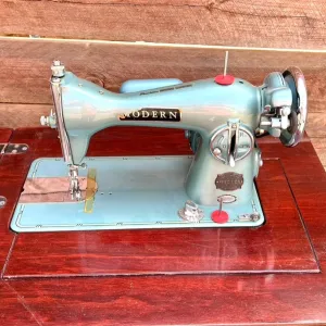 Sleek Modern Aqua Sewing Machine In Cabinet