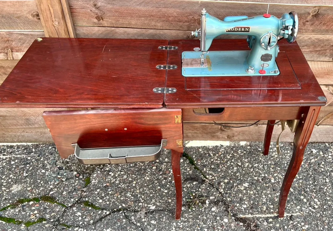 Sleek Modern Aqua Sewing Machine In Cabinet